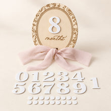 Load image into Gallery viewer, Interchangeable wooden baby milestone disc with white numbers and pink bow
