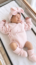 Load image into Gallery viewer, Close-up of personalized powder pink baby romper with matching headband and booties
